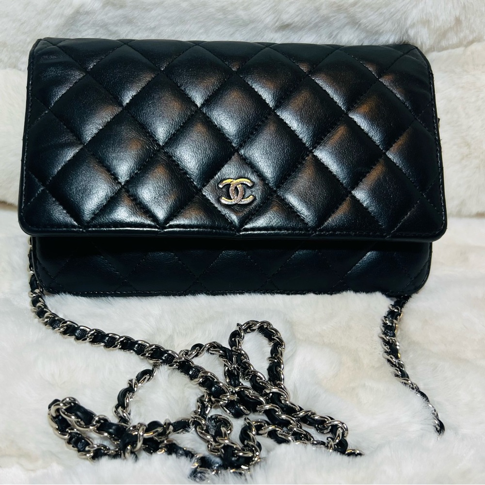 CHANEL Black WOC Quilted Crossbody Bag with silver hardware.
